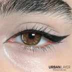 Close-up of Cleopatra Gold Urban Layer colored contact lenses by Urban-Layer, showing the gold and brown design on the eye.