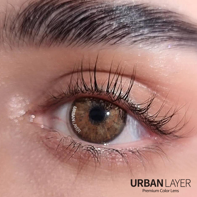 Close-up of Urban-Layer Gemini Hazel Urban Layer colored contact lenses, showing the detailed hazel design in a natural eye appearance.