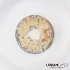Urban-Layer Gemini Hazel Urban Layer colored contact lenses worn in an eye, showcasing the hazel tint and subtle design details.