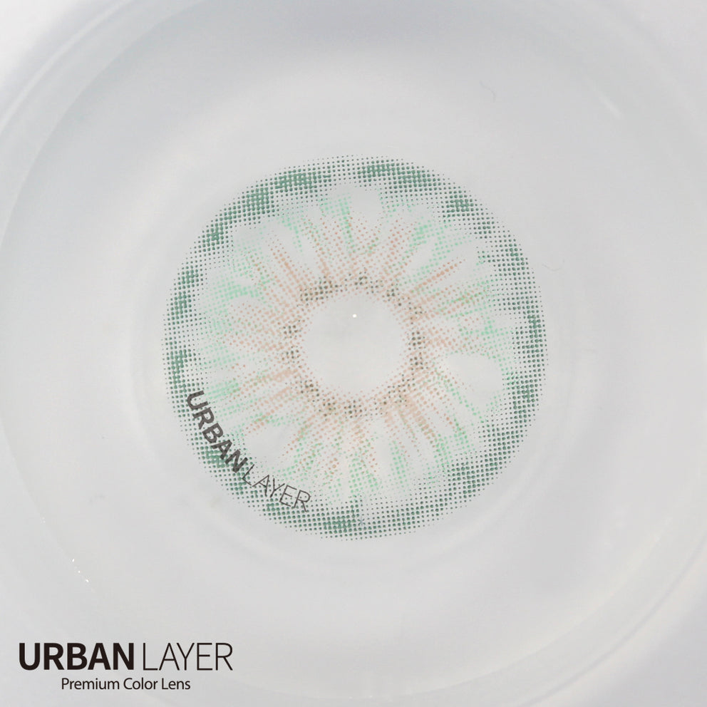 Hockney Emerald Urban-Layer colored contact lenses in a vibrant green shade, displayed in a clear lens case.